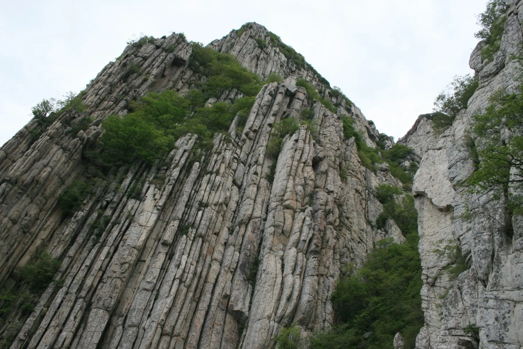 Mount Shaoshi in the Songshan range, Henan — sheer quartzite cliffs above the Shaolin Temple
